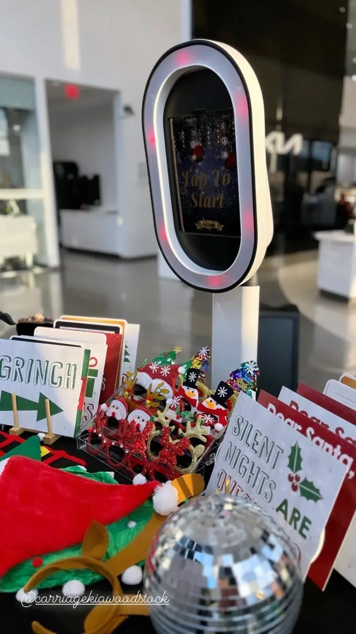Close-up of the photo booth screen and holiday props at a dealership event