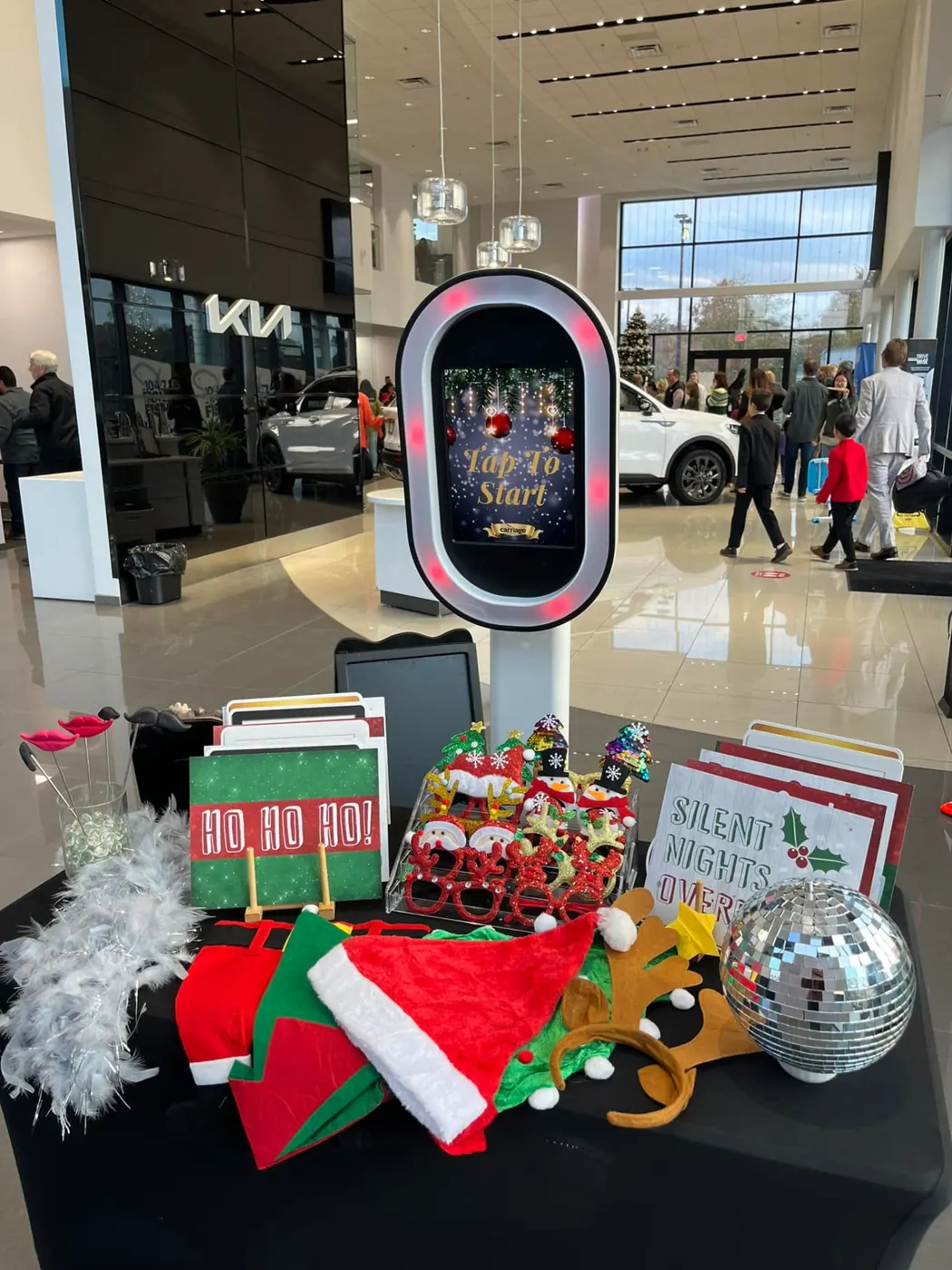 Holiday photo booth activation with props at a Kia dealership event